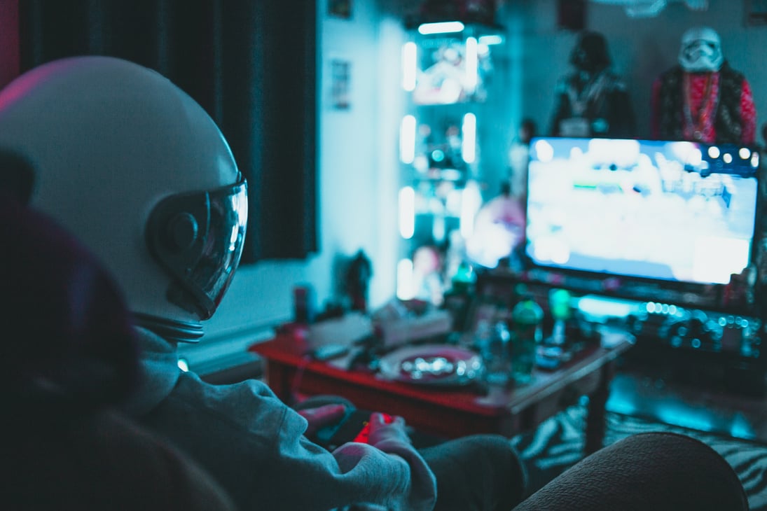 Gamer playing video game in dark room